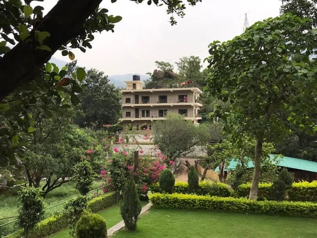 Leafy gardens and retreat accommodation at Yoga Vidya Mandiram in Rishikesh